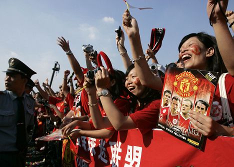 Fans of Manchester United cheers during a promotional event in China's southern city of Guangzhou