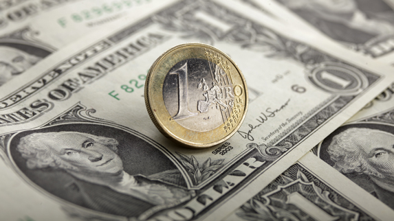 A picture illustration taken in Warsaw shows a one euro coin on one U.S. dollar banknotes