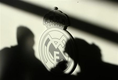 Shadow of reporters are seen on Real Madrid's logo during a news conference with Real Madrid new coach Ramos in Madrid