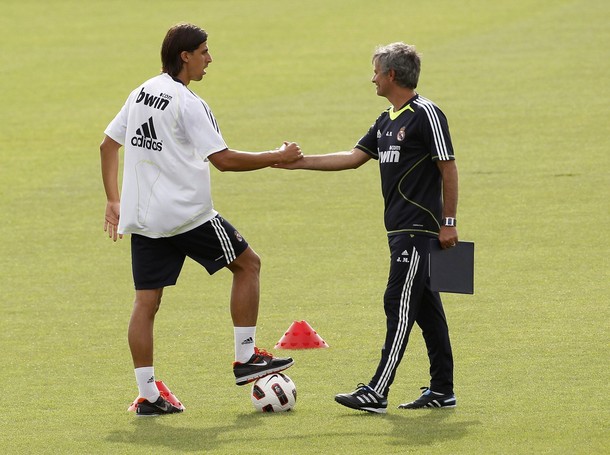 Real Madrid midfielder Khedira shakes hands with Real Madrid coach Mourinho during a training session at Real Madrid's training grounds in Valdebebas, outside Madrid