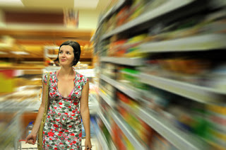 Young woman shopping in market with basket in hand
