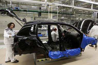 Employees at a Volkswagen factory work on an assembly line in the city of Kaluga