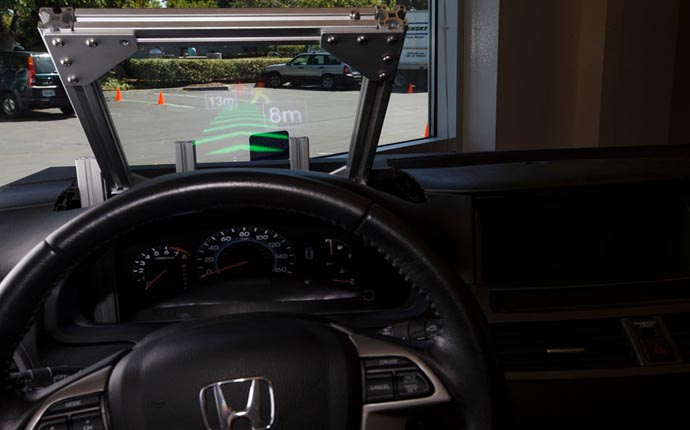 "Honda's "3D Head-Up Display" is demonstrated for an attendee during a press event on Thursday, July 23, 2015 at Honda's new research and development facility in Mountain View. (Dai Sugano/Bay Area News Group)"