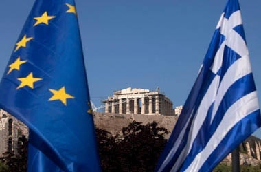 A European Union flag, left, hangs beside a Greek national flag beneath the Parthenon temple on Acropolis hill in Athens, Greece, on Tuesday, May 1, 2012. It is "entirely possible" IMF, EU will refuse to make next payment to Greece if new govt doesn't fulfill its commitments, UBS's Stephane Deo says in note to clients before May 6 elections. Photographer: Simon Dawson/Bloomberg