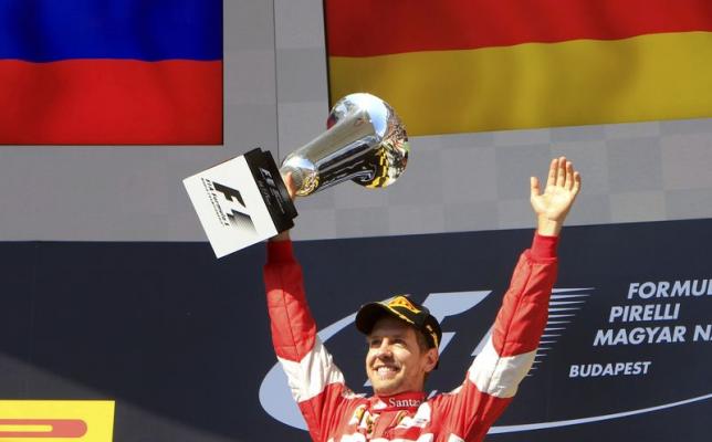Winner Ferrari Formula One driver Sebastian Vettel of Germany celebrates with the trophy after the Hungarian F1 Grand Prix at the Hungaroring circuit, near Budapest, Hungary July 26, 2015. REUTERS/Bernadett Szabo