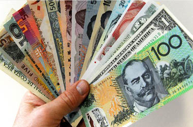 A 100 Australian dollar note (R) is displayed with other foreign currencies in Sydney on May 26, 2010. The plunge in the Australian dollar, which has hit nine-month lows, is due to traders selling down the local currency amid recent sharp falls on the share market and fresh concerns about the stability of Europe's financial system.  AFP PHOTO / Torsten BLACKWOOD        (Photo credit should read TORSTEN BLACKWOOD/AFP/GettyImages)