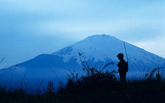 01 Aug 1989, Fuji-Hakone-Izu National Park, Japan --- Military training for female members of the Japanese Self Defense forces. A young woman warrior takes a lunch break during two days of field training near Mt. Fuji. Women comprise about 2% of all military personnel. The training is relatively light in comparison to that received by women in U.S. armed forces, involving in this case a 10 kilometer hike, and crawling through the grass. --- Image by © Karen Kasmauski/Corbis