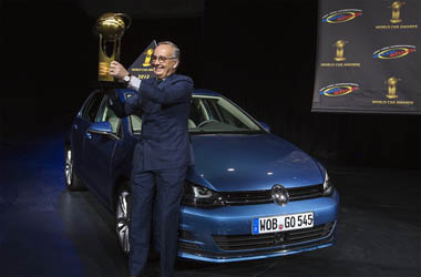 Volkswagen design chief de Silva holds a trophy after the Volkswagen Golf was named World Car of the Year in New York