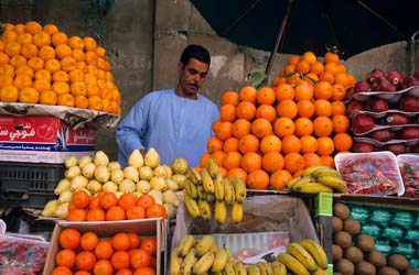 Market vendor selling fruit in a bazaar, Aswan, Egypt.