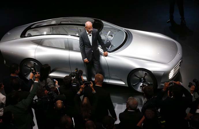 Daimler CEO Dieter Zetsche stands in front of a Mercedes show car 'Digital Transformer' during an event of the Daimler group on the eve of the Frankfurt Auto Show IAA in Frankfurt, Germany, Monday, Sept. 14, 2015. (AP Photo/Michael Probst)