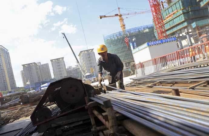 A worker processes reinforcing steel, also called rebar, at a construction site in Beijing, China, on Tuesday, Aug. 21, 2012. China has over the past two years raised down-payment and mortgage requirements, imposed a property tax for the first time in Shanghai and Chongqing, increased building of low-cost social housing, and placed home-purchase restrictions in about 40 cities. Photographer: Nelson Ching/Bloomberg