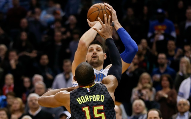 Feb 7, 2016; Orlando, FL, USA;  Atlanta Hawks center Al Horford (15) tries to block the shot of Orlando Magic center Nikola Vucevic (rear) who made the game winning basket with under a second to go in the game at Amway Center. The Magic won 96-94. Mandatory Credit: Reinhold Matay-USA TODAY Sports