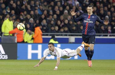 Paris Saint Germain's Zlatan Ibrahimovic, right, challenges Lyon's Olivier Michel Kemen for the ball during their French League One soccer match in Decines, near Lyon, central France, Sunday, Feb. 28, 2016. (AP Photo/Laurent Cipriani)