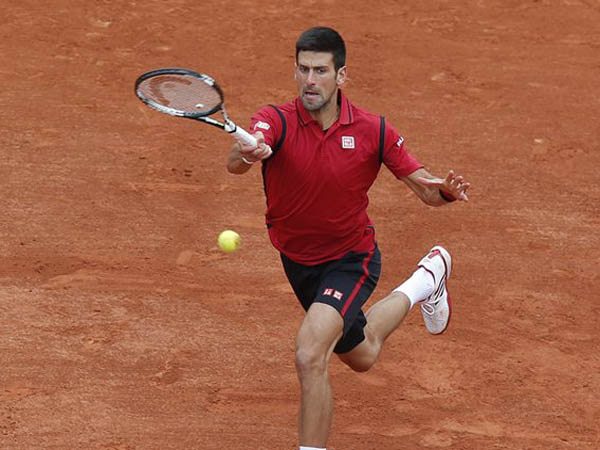 Serbia's Novak Djokovic returns in his first round match of the French Open tennis tournament against Yen-Hsun Lu of Taiwan at the Roland Garros stadium in Paris, France, Tuesday, May 24, 2016. (AP Photo/Michel Euler)