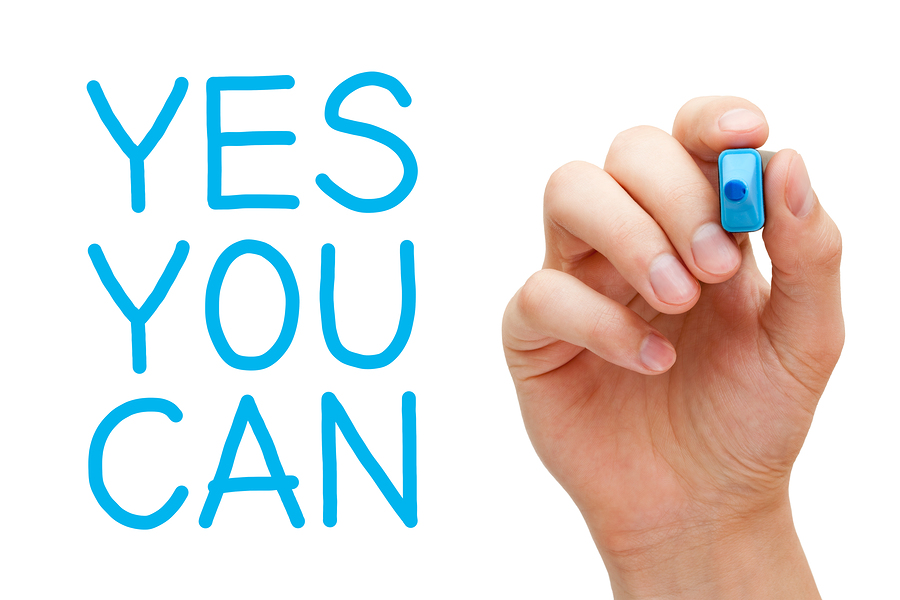 Yes You Can and hand holding blue marker.