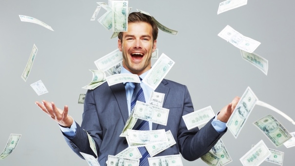 Studio shot of a well dressed man tossing money up in the air around him