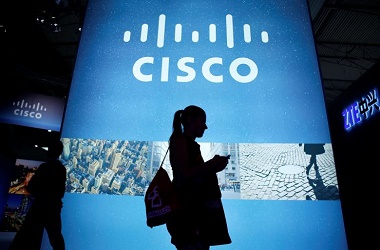 File photo of a visitor walking past a Cisco advertising panel at the Mobile World Congress in Barcelona