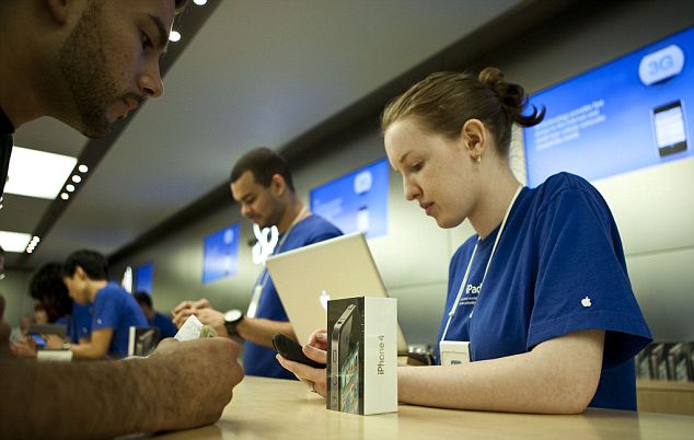 An Apple store employee activates a new iPhone 4 for a customer at the flagship Apple store on Fifth Avenue in New York, on Thursday, June 24, 2010.