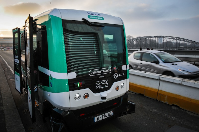 A self-driving bus shuttles between Austrelitz station and Lyon station in Paris, produced by Easymile company in Paris on January 23, 2017. The RATP tests two autonomous and electric minibuses in Paris, they will transport passengers between the stations of Lyon and Austerlitz for a little over two months free of charge on a dedicated lane. / AFP PHOTO / GEOFFROY VAN DER HASSELT