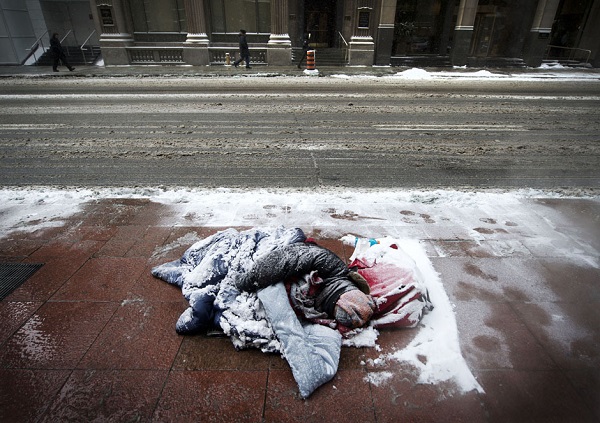 TORONTO, ONTARIO: JANUARY 22, 2013 -- HOMELESS WINTER -- A man is covered in snow while sleeping on the sidewalk in Toronto's Financial District as temperatures dip to -25 degrees with windchill on Tuesday, January 22, 2013. (Darren Calabrese/National Post) //NATIONAL POST STAFF PHOTO