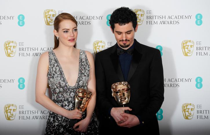 Emma Stone and Damien Chazelle hold their awards for 'La La Land' at the British Academy of Film and Television Awards (BAFTA) at the Royal Albert Hall in London, Britain, February 12, 2017. REUTERS/Toby Melville