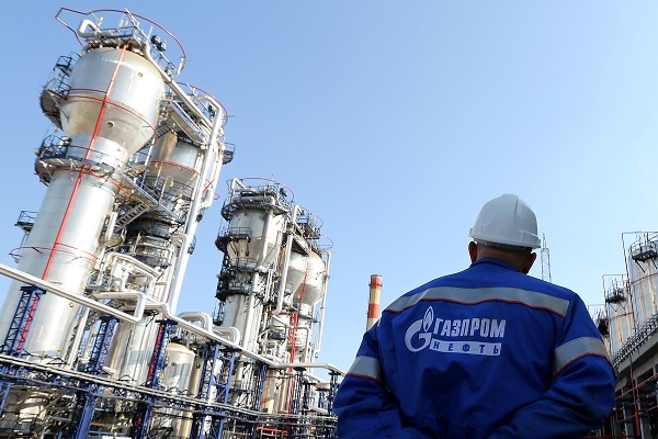 A Gazprom employee stands near to the new bitumen processor at the OAO Gazprom Neft oil refinery in Moscow, Russia, on Thursday, Sept. 20, 2012. OAO Gazprom Neft, the oil arm of Russia's state-run natural-gas producer, started operating a 3.2 billion-ruble ($100 million) bitumen processor at its Moscow refinery this month as it seeks to reduce pollution. Photographer: Andrey Rudakov/Bloomberg