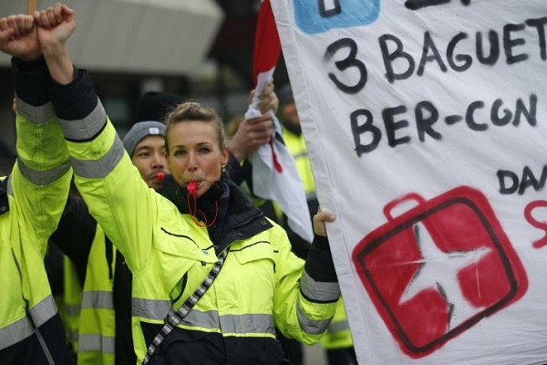 A member of Verdi union takes part in a warning strike at Berlin Tegel airport