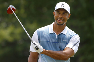 Tiger Woods of the United States smiles while warming up on the practice range at the 2014 PGA Championship at Valhalla Golf Course in Louisville, Kentucky August 6, 2014.     REUTERS/Brian Snyder  (UNITED STATES - Tags: SPORT GOLF)
